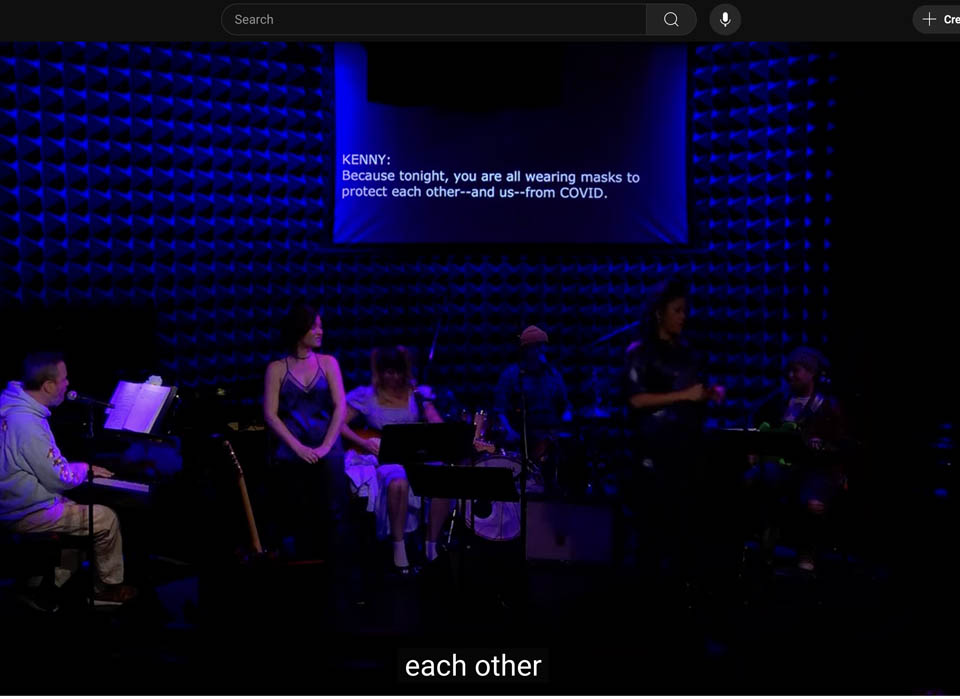 The performers and the words "each other" generated on screen
